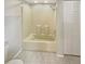 Bathroom features tub and shower combo with tiled flooring and built in shelving at 1912 Cattleya Dr, Kissimmee, FL 34741