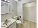 Clean bathroom with a vanity sink, toilet, and an open closet space with wire shelving at 1912 Cattleya Dr, Kissimmee, FL 34741