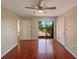 Cozy bedroom featuring wood floors, ceiling fan, closet and sliding glass door leading to a deck at 1912 Cattleya Dr, Kissimmee, FL 34741