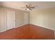 Spacious bedroom with hardwood floors, ceiling fan, and neutral walls at 1912 Cattleya Dr, Kissimmee, FL 34741