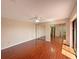 Spacious bedroom featuring ceiling fan, wood flooring and large mirrored closet at 1912 Cattleya Dr, Kissimmee, FL 34741
