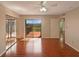 Bedroom features wood flooring, ceiling fan and access to a private balcony at 1912 Cattleya Dr, Kissimmee, FL 34741