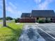 A condo shows a wood fence, bushes, and a gray roof on a sunny day at 1912 Cattleya Dr, Kissimmee, FL 34741