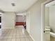 Open hallway with tile floors, leading to a living area with wood floors and a view of the bathroom at 1912 Cattleya Dr, Kissimmee, FL 34741
