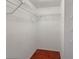 Walk-in closet features hanging wire shelving and wood flooring at 1912 Cattleya Dr, Kissimmee, FL 34741