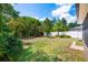 Expansive backyard featuring a white fence, lush green lawn, and mature trees providing privacy at 2020 Corner Glen Dr, Orlando, FL 32820