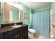 Bathroom vanity featuring a dark wood cabinet, granite countertop, shuttered mirror and shower with curtain at 2020 Corner Glen Dr, Orlando, FL 32820
