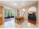 Cozy dining area with tiled floors, archways, and sliding glass doors to a screened porch at 2020 Corner Glen Dr, Orlando, FL 32820