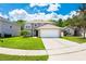 Charming two-story home with a well-manicured lawn and a spacious driveway leading to a two-car garage at 2020 Corner Glen Dr, Orlando, FL 32820