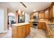 Modern kitchen with stainless steel appliances, center island, granite countertops and wooden cabinets at 2020 Corner Glen Dr, Orlando, FL 32820