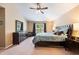 Spacious main bedroom featuring a ceiling fan, large window, and dark wood furniture at 2020 Corner Glen Dr, Orlando, FL 32820
