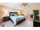 Comfortable bedroom featuring a queen-sized bed, a ceiling fan and an ensuite bathroom at 2020 Corner Glen Dr, Orlando, FL 32820