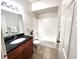 Bathroom featuring granite countertop, wooden cabinets, and shower/tub combination at 2528 Robert Trent Jones Dr # 1617, Orlando, FL 32835