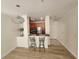 Open living space with barstool seating, a modern pendant light and wood flooring at 2528 Robert Trent Jones Dr # 1617, Orlando, FL 32835
