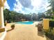 A community pool surrounded by lounge chairs and mature landscaping is perfect for relaxation at 2528 Robert Trent Jones Dr # 1617, Orlando, FL 32835