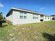 Exterior: View of backyard and the home's windows and covered patio at 2731 Forestdale St, St Cloud, FL 34771