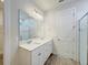 Bathroom with a double sink vanity, modern lighting fixtures, and a large mirror over the sinks at 2731 Forestdale St, St Cloud, FL 34771