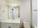 Bright bathroom features a white vanity with a quartz countertop and a large mirror at 2731 Forestdale St, St Cloud, FL 34771