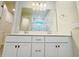 Bright bathroom featuring a dual sink vanity with a large mirror and ample lighting at 2731 Forestdale St, St Cloud, FL 34771