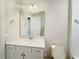 Bright bathroom features a white vanity with a quartz countertop and a large mirror at 2731 Forestdale St, St Cloud, FL 34771