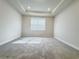 Well-lit bedroom with soft carpeting, tray ceiling, recessed lights, and natural light from a window at 2731 Forestdale St, St Cloud, FL 34771
