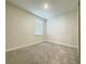 Neutral bedroom offers a carpeted floor and a window with bright, natural light at 2731 Forestdale St, St Cloud, FL 34771