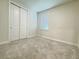 Bedroom featuring neutral carpet, bright window, and closet at 2731 Forestdale St, St Cloud, FL 34771