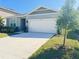 Inviting single-story home with a well-manicured lawn and a two-car garage at 2731 Forestdale St, St Cloud, FL 34771