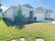 Well-maintained single-story home with a two-car garage, lush lawn, and landscaped garden at 2731 Forestdale St, St Cloud, FL 34771