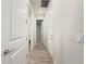 Hallway with wood floors leading to bedrooms and a laundry room at 2731 Forestdale St, St Cloud, FL 34771