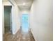 Bright hallway featuring wood-look floors that lead to a light-filled living area at 2731 Forestdale St, St Cloud, FL 34771