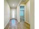 Hallway with wood floors leading to a bedroom and an exterior door at 2731 Forestdale St, St Cloud, FL 34771