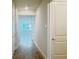 Light-filled hallway with wood-look floors leading to a bright living space at 2731 Forestdale St, St Cloud, FL 34771