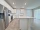 Kitchen featuring stainless steel appliances, white cabinets, and island at 2731 Forestdale St, St Cloud, FL 34771