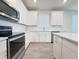 Kitchen showcasing stainless steel appliances and white cabinets at 2731 Forestdale St, St Cloud, FL 34771