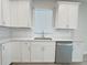 Kitchen with white cabinets, stainless steel appliances, and tile backsplash at 2731 Forestdale St, St Cloud, FL 34771