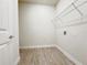 Laundry room featuring wood look tile flooring and overhead wire shelving at 2731 Forestdale St, St Cloud, FL 34771