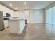 Large open-concept living area with wood-look floors and kitchen in the background at 2731 Forestdale St, St Cloud, FL 34771