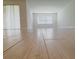 Bright and airy living space with sleek, light wood-look flooring, and large windows for an abundance of natural light at 2731 Forestdale St, St Cloud, FL 34771