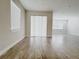 Open living room featuring modern wood-look floors, neutral paint and large window at 2731 Forestdale St, St Cloud, FL 34771