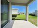 View of covered patio with a glimpse of the green grass and landscaped yard at 2731 Forestdale St, St Cloud, FL 34771