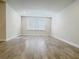 Empty room boasts neutral colors, hardwood floors, recessed lighting and natural light at 2731 Forestdale St, St Cloud, FL 34771