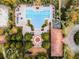 Aerial view showcasing a sparkling community pool, clubhouse, playground, and sunbathing area, surrounded by lush landscaping at 2795 Westyn Cove Ln, Ocoee, FL 34761