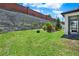 Lush backyard with green grass and landscaping against a brick wall, creating a serene outdoor setting at 2795 Westyn Cove Ln, Ocoee, FL 34761