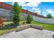 Landscaped backyard features a stone patio and privacy wall, offering a peaceful outdoor space at 2795 Westyn Cove Ln, Ocoee, FL 34761