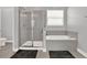 Neutral bathroom featuring tiled walls, bathtub, and glass shower at 2795 Westyn Cove Ln, Ocoee, FL 34761