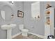 Cozy bathroom featuring a pedestal sink, toilet, and a decorative shelf, perfect for  at 2795 Westyn Cove Ln, Ocoee, FL 34761