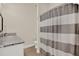Bright bathroom featuring a granite countertop vanity and a shower with a striped curtain at 2795 Westyn Cove Ln, Ocoee, FL 34761