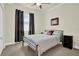 Bedroom with a neutral color scheme, tile flooring, and a comfortable bed at 2795 Westyn Cove Ln, Ocoee, FL 34761