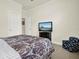 Bedroom featuring tile floors, bright window, and comfortable bed at 2795 Westyn Cove Ln, Ocoee, FL 34761